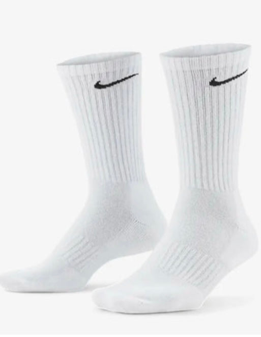 White crew socks with ribbed texture and black Nike logo on a plain background