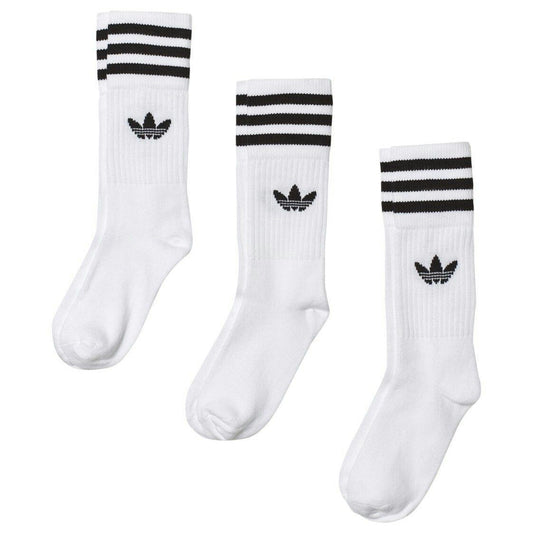 Three pairs of white Adidas crew socks with black stripes and trefoil logo on a plain background